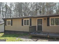 Charming single-story home features a covered front porch and neutral siding at 97 College St, Temple, GA 30179