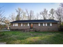 Charming brick ranch home featuring a well-maintained front yard and classic curb appeal at 1326 Hatchcover Cir, Jonesboro, GA 30238