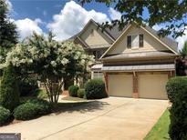 Stately two-story brick home featuring well-manicured landscaping and a two-car garage at 2741 Willowstone Dr, Duluth, GA 30096