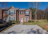 Charming two-story townhome with a well-maintained lawn and driveway at 1942 Grove Way, Hampton, GA 30228