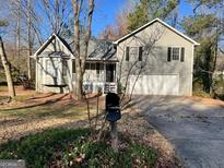 Split level home with two-car garage, well-maintained lawn and fresh paint at 1635 Kimble Sw Dr, Marietta, GA 30064