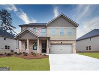 Charming two-story home with brick and siding exterior, featuring a two-car garage and well-manicured lawn at 1716 Goodwin Dr, Hampton, GA 30228