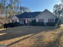 Traditional one-story home featuring a well-manicured lawn and mature landscaping, offering great curb appeal at 135 Lucky Leaf Pl, Fayetteville, GA 30214