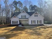 Beautiful two-story home with a manicured lawn, a tasteful mix of siding and stone accents, and dark shutters at 240 Jay Trl, Fayetteville, GA 30215