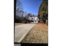 Charming two-story home with attached two-car garage and large front yard at 332 Black Willow Ct, Locust Grove, GA 30248