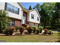 Charming home with tidy front yard, colorful bushes and siding at 332 Black Willow Ct, Locust Grove, GA 30248