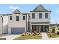 A bright, modern two-story townhouse features a two-car garage and striking curb appeal at 982 Sutherland Ln # 30, Lawrenceville, GA 30043
