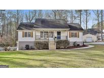 Charming ranch-style home featuring shuttered windows and a welcoming front porch at 75 Rockland Dr, Sharpsburg, GA 30277