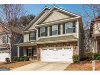 Charming two-story home with a stone-accented facade, two-car garage, and well-maintained landscaping at 903 Hollytree Pl, Acworth, GA 30102
