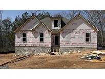 Unfinished exterior view of a single-Gathering home under construction with visible building materials at 4139 Alayna Lee Cir, Mcdonough, GA 30252