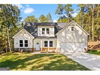 Charming two-story home with a two-car garage and manicured front lawn, nestled among mature trees at 485 N Oakland Circle, Mcdonough, GA 30253