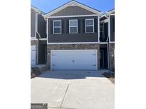 Charming townhome featuring a 2-car garage, brick accents, and a neutral color palette at 11519 Kimberly Way # 4, Hampton, GA 30228