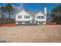 Charming two-story home with a spacious front yard and inviting deck at 31 Pecan Lake Ct, Sharpsburg, GA 30277
