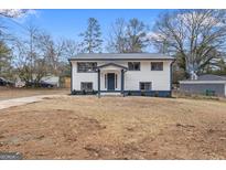 Charming two-story home with a neatly landscaped front yard and driveway at 1276 Pineglen Dr, Riverdale, GA 30296
