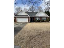Charming ranch home featuring a two-car garage and a well-maintained front yard at 628 Morningside Dr, Stockbridge, GA 30281