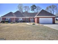 Charming single-story brick home with an attached two-car garage and a well-manicured lawn at 2808 Autumn Lake Ln # D/6, Decatur, GA 30034