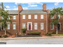 Charming brick townhouse with a red front door and classic architectural details at 180 Habersham Pl, Fayetteville, GA 30214