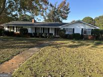Charming single-story home featuring a manicured lawn and a welcoming entrance at 4634 Bexley Dr, Stone Mountain, GA 30083