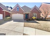 Charming brick home featuring manicured landscaping and a two-car garage at 1832 Glenwood Ln, Snellville, GA 30078