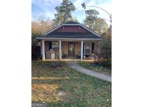 Cozy single-story home with a covered front porch and mature trees at 495 S Gordon Sw Rd, Mableton, GA 30126