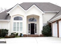 Inviting front entrance featuring an arched doorway and decorative windows in a bright and well maintained home at 5188 Ashley Se Dr, Covington, GA 30014
