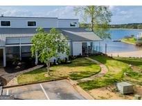 Lakefront townhome featuring a stone pathway to covered porch, metal roof, and lake views at 277 Clearview Ct, Villa Rica, GA 30180
