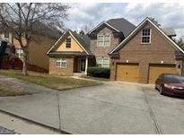 Charming brick two-story home featuring a two-car garage and well-maintained front yard at 4371 Minkslide Sw Dr, South Fulton, GA 30331