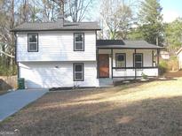 Charming two-story home with a welcoming front porch and a well-maintained yard at 5017 Galbraith Cir, Stone Mountain, GA 30088