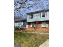 Charming front exterior featuring a combination of brick and light blue siding at 5626 Pine Gate Pine Gate Dr, Riverdale, GA 30349