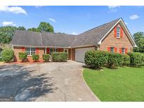 Charming brick home with well-maintained landscaping and a spacious driveway at 217 Crystal Ct, Hampton, GA 30228