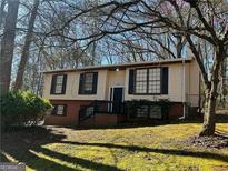 Charming home with light siding, black shutters, and a well-maintained lawn at 6625 Paula Ct, Lithonia, GA 30038