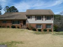 Charming two-story home featuring a blend of brick and siding, complemented by well-maintained landscaping at 4228 Rocky Ledge Way, Snellville, GA 30039