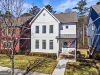 Charming two-story home featuring a quaint front porch, white siding, and a well-manicured lawn at 5135 Arnold St, Covington, GA 30014