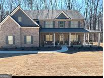 Charming two-story home with a large front porch and a well-maintained lawn at 830 Turner Rd, Mcdonough, GA 30252