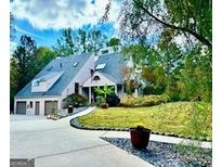 Charming exterior showcasing unique architectural details, lush landscaping, and inviting curb appeal at 3810 Galloway Ne Dr, Roswell, GA 30075