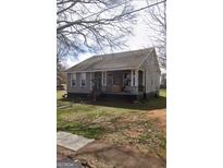 Charming single-story home featuring a welcoming front porch and a well-maintained front yard at 205 Cranford St, Palmetto, GA 30268