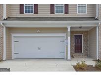 Two-story home features a two-car garage, brick entryway, and a classic design at 2990 Fareed St, Douglasville, GA 30135