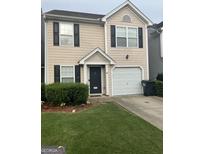 Charming two-story home with a well-manicured lawn and attached one-car garage at 45 Fieldview Ln, Covington, GA 30016