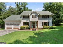 Charming two-story home with a well-manicured lawn and a two-car garage, perfect for families at 2612 New Haven Dr, Jonesboro, GA 30236