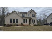 Beautiful two-story brick home with professionally landscaped yard and manicured lawn at 336 Traditions Ln # 147, Hampton, GA 30228