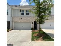 Charming townhome with a brick facade and a one-car garage at 3579 Silvery Way, Powder Springs, GA 30127