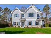 Charming two-story home with light-blue siding, a well-kept lawn, and classic blue shutters at 3725 Heron Creek Ct, Loganville, GA 30052