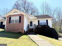 Cozy one-story house featuring vinyl siding, brick accents, manicured landscaping, and charming front entrance at 209 East Wilson St # 25, Villa Rica, GA 30180