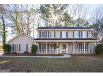 Charming two-story home with a welcoming front porch and a well-maintained yard at 403 Sandown Dr, Peachtree City, GA 30269