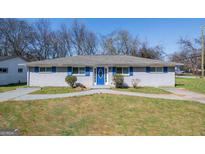 Single-story home with blue trim, including shutters and front door at 1393 Vesta Ave, Atlanta, GA 30344