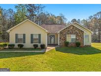 Charming single-story home features a stone accent wall, well-maintained lawn, and inviting front entrance at 425 Wendy Ct, Mcdonough, GA 30252