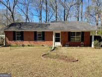 Charming single-story brick home with a well-maintained lawn and a classic, welcoming exterior at 924 Polk Rd, Moreland, GA 30259