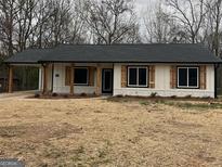 Charming single-story home featuring a covered parking area and attractive wooden shutters at 3075 Fairburn Rd, Douglasville, GA 30135