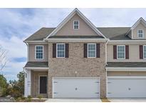 Charming townhome showcasing brick facade and attached one-car garage at 2851 Fareed St, Douglasville, GA 30135