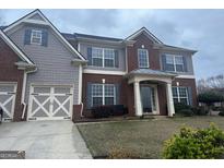 Charming two-story home featuring a mix of brick and shake siding, complemented by a well-manicured lawn at 8908 Brandy Rose, Douglasville, GA 30134